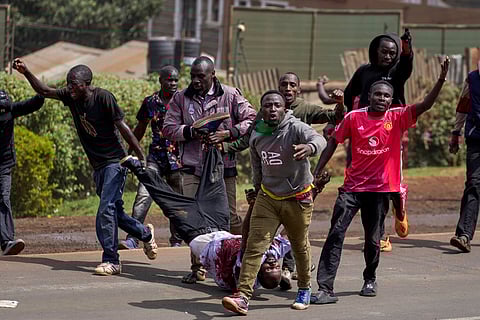 Protesters carry a man who the crowd claimed had been shot by police during demonstrations to mark the historic 1990 Saba Saba (a Swahili word that means seven seven) protests for democratic reforms in the Kangemi slum of Nairobi, Kenya, Monday, July 7, 2025.