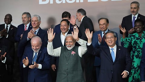Brazilian President Luiz Inacio Lula da Silva, left, Indias Prime Minister Narendra Modi, center, and Chinas Premier Li Qiang take part in a group photo during the 17th annual BRICS summit in Rio de Janeiro, Monday, July 7, 2025