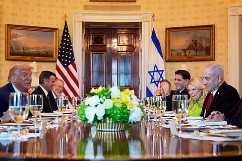 President Donald Trump, left, meets with Israel's Prime Minister Benjamin Netanyahu, right, as CIA Director John Ratcliffe, from second left, U.S. Ambassador to Israel Mike Huckabee, and from second right, Netanyahu's wife Sara Netanyahu, Israel's Strategic Affairs Minister Ron Dermer, Israel's National Security Council head Tzachi Hanegbi, obstructed, and Israel's Cabinet Secretary Yossi Fuchs listen in the Blue Room of the White House, Monday, July 7, 2025