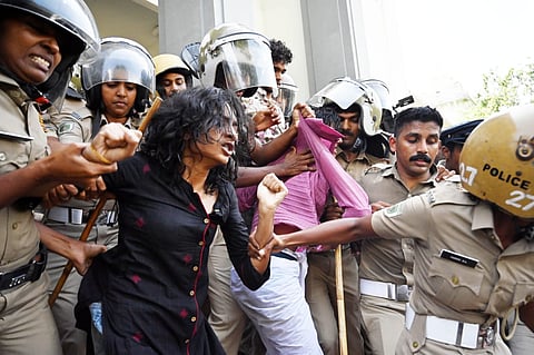 Police arrest and remove SFI activists who were protesting after marching towards the university headquarters in connection with an agitation.