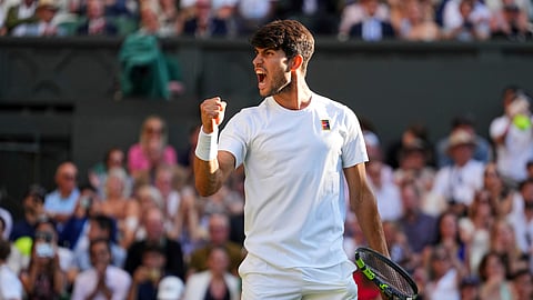 Spain's Carlos Alcaraz celebrates after beating Britain's Cameron Norrie during a quarterfinal men's singles match at the Wimbledon Tennis Championships in London, Tuesday, July 8, 2025.