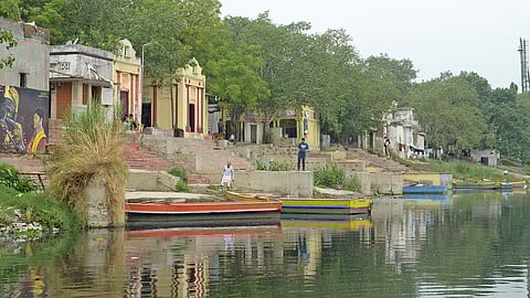 A scenic view of Nigambodh Ghat, where boats are anchored in Yamuna.