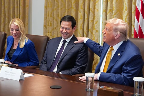 President Donald Trump, right, puts his hand on shoulder of Secretary of State Marco Rubio, center, as Attorney General Pam Bondi, left, looks on during a cabinet meeting at the White House, Tuesday, July 8, 2025, in Washington.