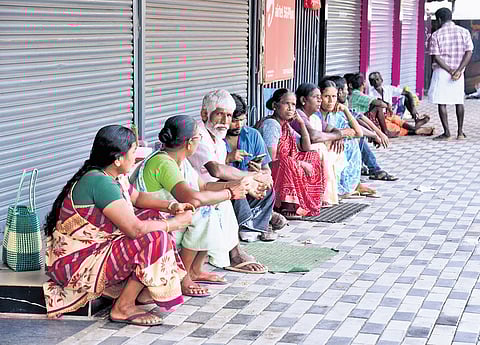 Migrant labourers wait for work at Kaloor on Wednesday morning. Life in the city was severely crippled following the 24-hour nationwide strike called by a coalition of 10 trade unions