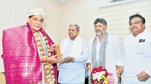 CM Siddaramaiah, accompanied by Deputy CM DK Shivakumar and Industries Minister MB Patil, greets Defence Minister Rajnath Singh in New Delhi on Wednesday