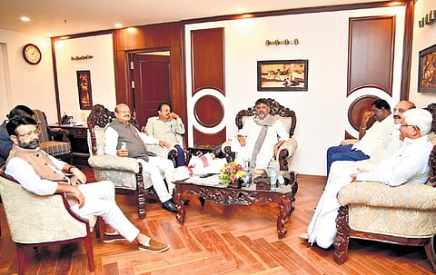 Deputy Chief Minister DK Shivakumar, who is also state Congress president, interacts with Congress legislators from Karnataka, in New Delhi on Wednesday