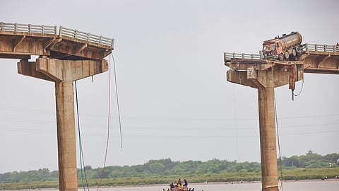 Rescuers and locals look for survivors after several vehicles fell into a river following the collapse of a portion of a bridge in Mujpur near Vadodara in Gujarat, Wednesday, July 9, 2025.