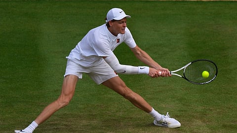 Jannik Sinner of Italy plays a return to Ben Shelton of the US during the men's singles quarterfinal match at the Wimbledon Tennis Championships in London, Wednesday, July 9, 2025.