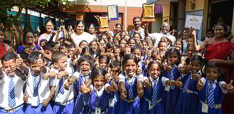 Students and staffs of Puttur Corporation middle school cheering with the prestigious awards in Tiruchy on Wednesday.