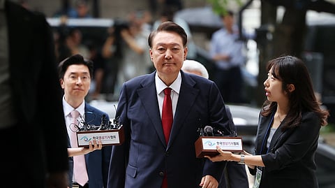 South Korea's former impeached president Yoon Suk Yeol (C) arrives at a court to attend a hearing to review his arrest warrant requested by special prosecutors, in Seoul on July 9, 2025