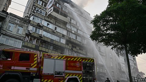 Ukrainian firefighters extinguish a fire in a residential building following a Russian missile and drone attack in Kyiv on July 10, 2025, amid the Russian invasion of Ukraine. Russian strikes on Ukraine's capital Kyiv killed at least two people, the city's military administration said on July 10.
