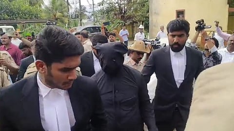 The complainant was granted witness protection as per his request. Here, he is seen clad in black clothing to hide his identity.