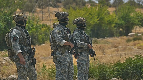 Forces of the regional Kurdish administration secure the area of the Jasana Cave ahead of a symbolic disarmament ceremony by the separatist PKK group as part of the peace process with Turkey, in Sulaymaniyah governorate, Iraq, Friday, July 11, 2025.