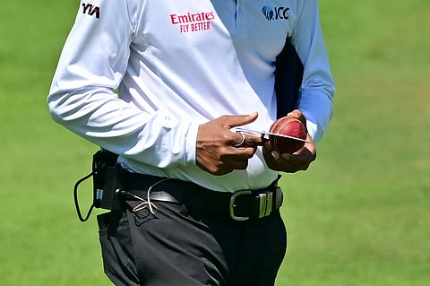 Umpire checks the ball during day three of the third Test at Lord's