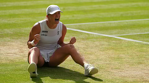 Iga Swiatek of Poland celebrates winning the women's singles final match against Amanda Anisimova of the U.S. at the Wimbledon Tennis Championships in London, Saturday, July 12, 2025.