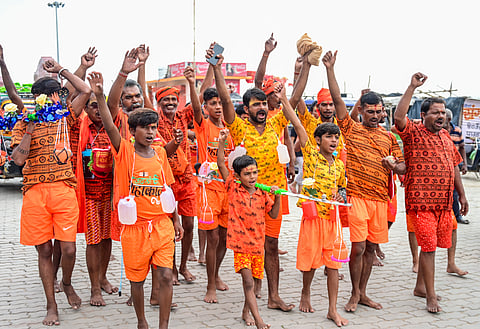 Kanwariyas leave for Varanasi after taking the holy water of River Ganga for Lord Shivas worship, on the first day of the holy month of Shravan, in Prayagraj.