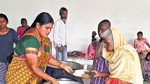 An elderly woman being served food at an old age home in Nalgonda