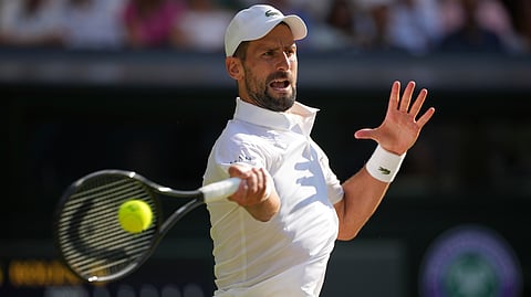 Serbia's Novak Djokovic returns to Italy's Jannik Sinner in a men's singles semifinal at the Wimbledon Tennis Championships in London, Friday, July 11, 2025