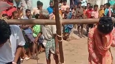 Video grab of the couple being forced to pull a plough in Narayanapatana block