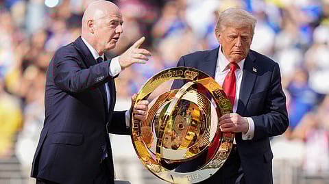 FIFA President Gianni Infantino, left, and President Donald Trump carry the championship trophy after the Club World Cup final soccer match between Paris Saint-Germain and Chelsea in East Rutherford, N.J., Sunday, July 13, 2025.