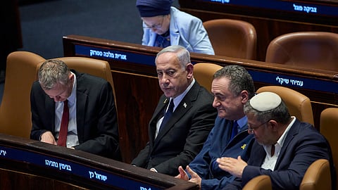 Israel's Prime Minister Benjamin Netanyahu, surrounded by ministers from the government attends a session of the Knesset, Israel's parliament, in Jerusalem, Monday, July 14, 2025.