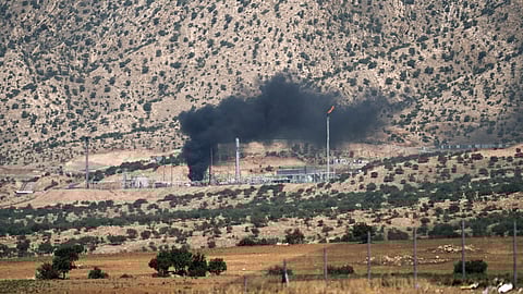 Smoke rises above an oil field following a drone attack on the outskirts of Zakho city in the Kurdistan Region of Iraq on July 16, 2025.
