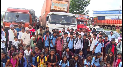 The Students and villagers of Konduskoppa village block
the national highway demanding bus service to their village.