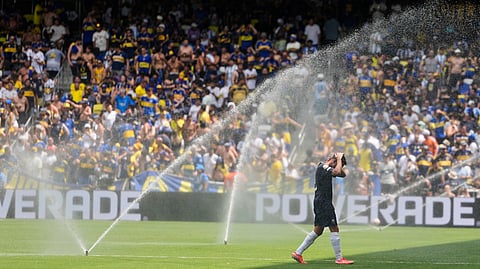 Auckland City's Gerard Garriga cools off under the sprinklers during a water break in the Club World Cup Group C soccer match between Auckland City and Boca Juniors in Nashville, Tenn., Tuesday, June 24, 2025.