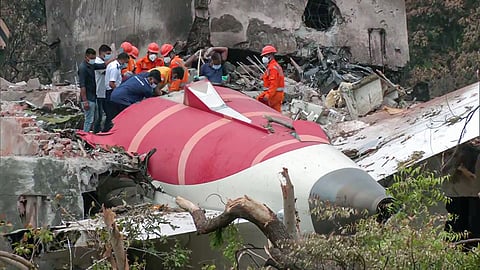 Officials inspect the wreckage of the London-bound Air India flight, which crashed on 12 June 2025, in Ahmedabad.