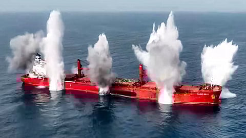 This handout picture released by Yemen's Houthi Ansarullah Media Centre on July 8, 2025, shows smoke plumes rising from reported explosions on the Liberia-flagged bulk carrier Magic Seas, which was attacked by Houthi-affiliated fighters at sea.
