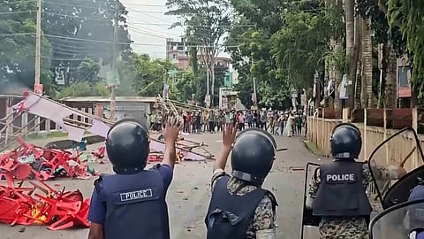 In this image made from a video, supporters of the ousted Prime Minister Sheikh Hasina clash with the police in Gopalganj, Bangladesh, Wednesday, July 16, 2025.