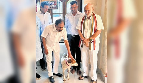The dog rescued from Shirur landslide seen with HM G Parameshwar at the residence of M Narayan, Uttara Kannada SP