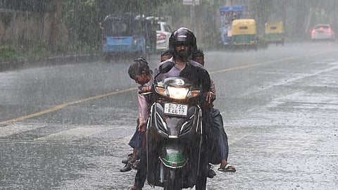 Commuters during rain in New Delhi on Wednesday, July 16, 2025.