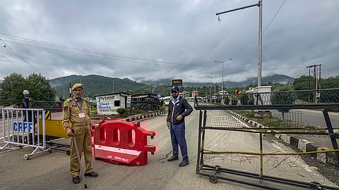 Security personnel stand guard on the Amarnath Yatra route, in Anantnag district, Thursday, July 17, 2025. The Amarnath Yatra was suspended from Jammu on Thursday following a weather advisory warning of heavy rain in many parts of Jammu and Kashmir.