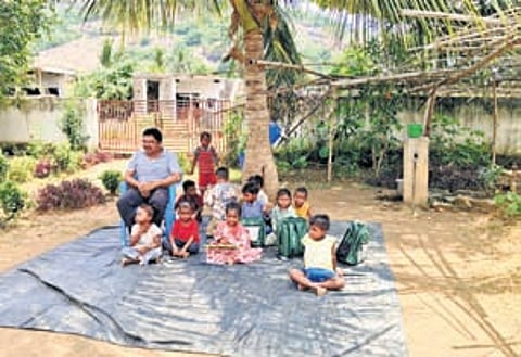 Children attend classes in an open-air school