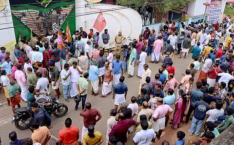 People gathered in front of the school in Kollam