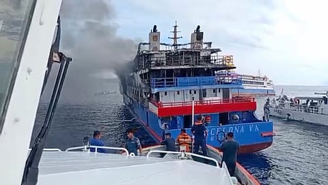 In this photo made from video released by the Indonesian National Search and Rescue Agency (BASARNAS), rescue ship approach passenger ship KM Barcelona after it caught fire in the waters off Talise Island in North Sulawesi, Indonesia, Sunday, July 20, 2025.
