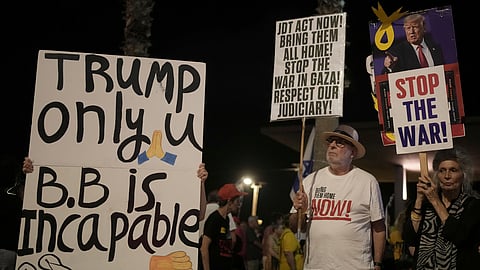 People take part in a protest outside US Embassy Branch demanding the end of the war and immediate release of hostages held by Hamas in the Gaza Strip, and against Prime Minister Benjamin Netanyahu's government in Tel Aviv, Israel, Saturday, July 19, 2025.