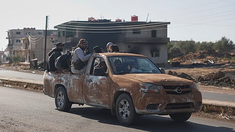 Bedouin fighters ride in a truck in Mazraa village on the outskirts of Sweida city, in southern Syria, Saturday, July 19, 2025.