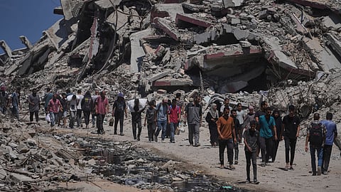 Palestinians carry sacks of humanitarian aid unloaded from trucks convoy that had been heading to Gaza City, in the northern Gaza Strip Sunday, July 20, 2025