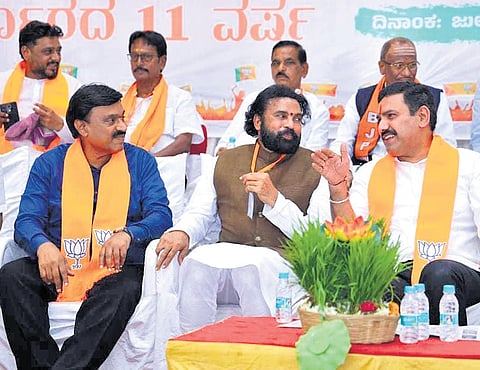 BJP state president BY Vijayendra shares a light moment with party colleagues, Gangavathi MLA Gali Janardhan Reddy and former minister B Sriramulu at a special party meeting in Koppal on Sunday.