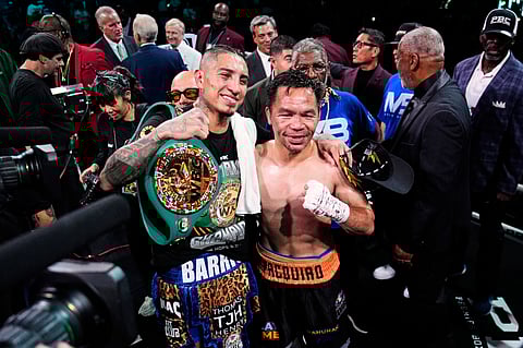 Mario Barrios, left, and Manny Pacquiao one for a photo after fighting to a majority draw in a welterweight title boxing match Saturday, July 19, 2025, in Las Vegas.