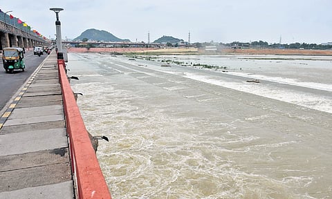 With continuous inflow from upstream, Prakasam Barrage officials lifted 10 crest gates to release 11,078 cusecs of water in Vijayawada on Monday.