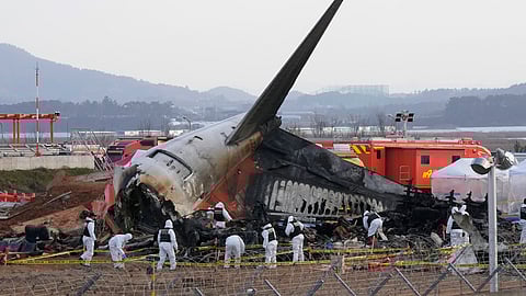 FILE - Rescue team members work at the site of a plane crash at Muan International Airport in Muan, South Korea on Dec. 31, 2024.