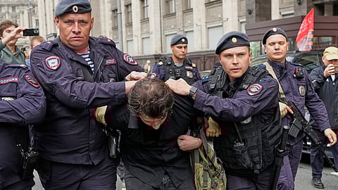 Police detain an activist during a picket against internet limitations in front of The State Duma, the lower house of the Russian Parliament, prior to consider the third and final reading of a bill, criminalising the search of "extremist materials" in Moscow, Russia, Tuesday, July 22, 2025.