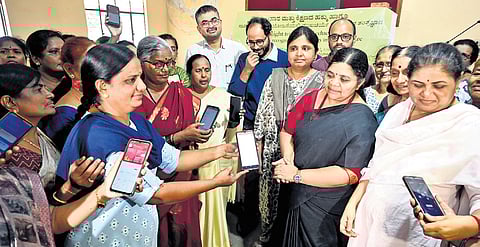 Anganwadi workers and activists attend an open meeting at Gandhi Bhavan in Bengaluru on Tuesday