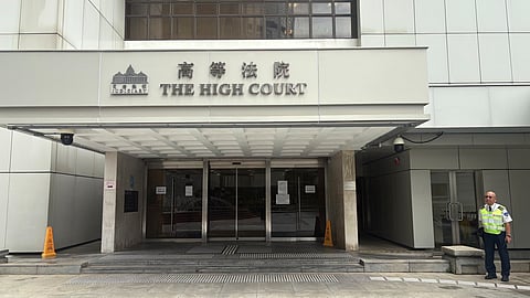 A security guard stands outside of Hong Kong's High Court in Admiralty, Hong Kong Wednesday, July 23, 2025.