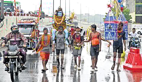 Kanwariyas carry the holy water of river Ganga for Lord Shivas worship during their pilgrimage in the month of Shravan, in New Delhi, Tuesday, July 22, 2025.