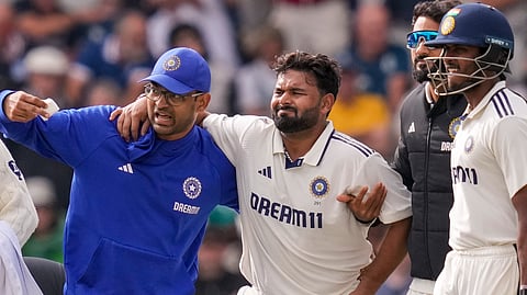 India's Rishabh Pant being assisted by a physio after an injury on day one of the fourth test cricket match between India and England, at the Old Trafford Cricket Ground, in Manchester, Wednesday, July 23, 2025