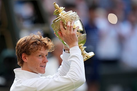 Italy's Jannik Sinner celebrates with the trophy after beating Carlos Alcaraz of Spain to win the men's singles final at the Wimbledon Tennis Championship.